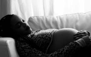 Woman pregnant with transverse baby sleeping in a semi optimal position.