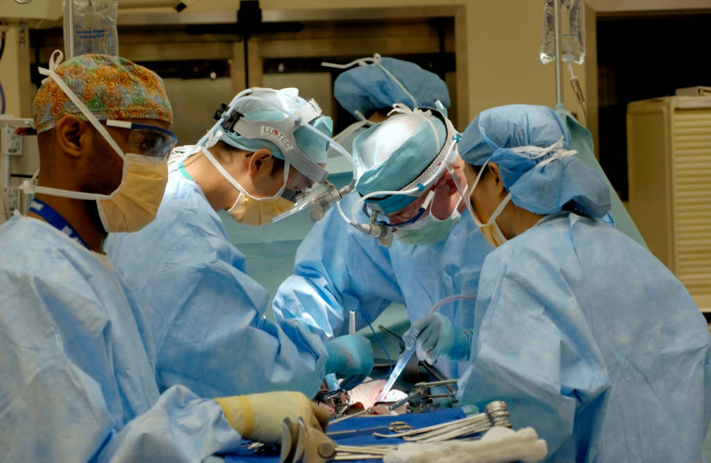 Surgical team conducting cerebral palsy surgery on patient.